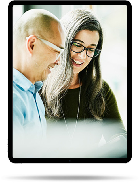 A businesswoman and businessman working together and smiling